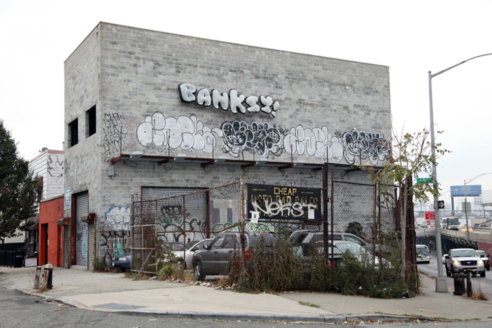 Grade: A<br/>Went up on <a href="http://gothamist.com/2013/10/31/new_banksy_is_in_queens.php#photo-1">October 31st</a><br/>Located on Borden Avenue in Queens<br/>(Photo via Kelly Weill/Gothamist)